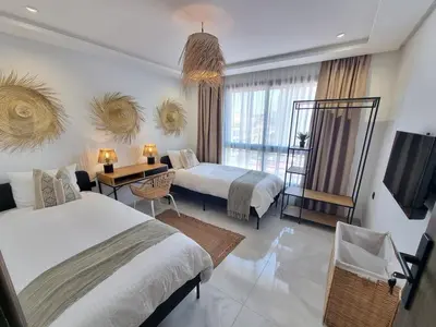 a hotel room with two beds and a television at downtown rabat luxury in Rabat