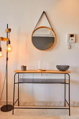 a table with a mirror on a wall at Le loft du soleil B living in Casablanca