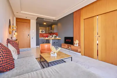 a living room with a couch and a table at Le loft du soleil B living in Casablanca