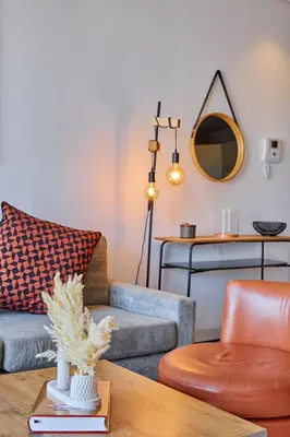 a living room with a couch and a mirror at Le loft du soleil B living in Casablanca