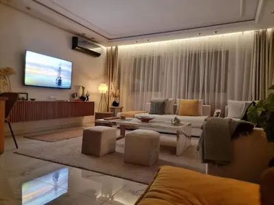 a living room with a couch and a tv at Blue paradise in Rabat