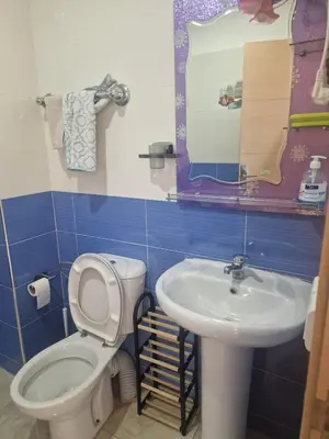 a bathroom with a toilet and a sink at APPARTEMENT DE LUXE 3 Façades in O Ben Slimane