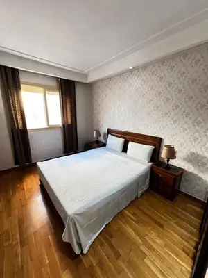 a bedroom with a large bed and a window at Complexe Horizon in Casablanca