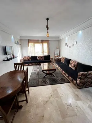 a living room with a couch and a table at Complexe Horizon in Casablanca