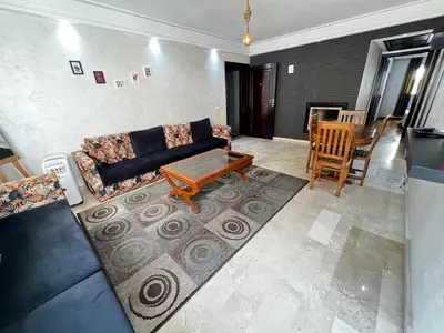 a living room with a couch and a table at Complexe Horizon in Casablanca