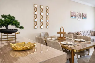 a dining room with a table and chairs at Walkable, Beach in 2, Terrace, DW, AC, PS4, WiFi in Mohammedia