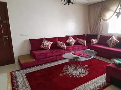 a living room with a red couch and a table at Casablanca in Casablanca