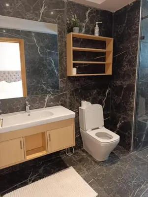 a bathroom with a toilet and a sink and a mirror at Hamza in Temara