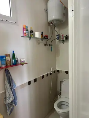 a bathroom with a toilet and a sink at Appartement Cosy Bord de Mer in Dar Mohammed Ould Haj Jilali