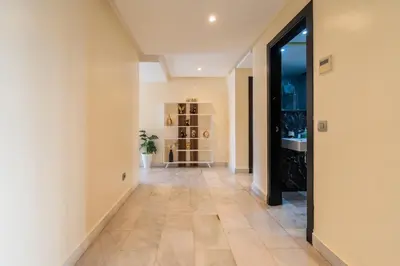 an empty hallway with a tile floor in a building at Yacht appartement Waterfront Complex 2 Bedrooms 2 Bathrooms in Casablanca