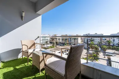 a balcony with chairs and a table with a view at Yacht appartement Waterfront Complex 2 Bedrooms 2 Bathrooms in Casablanca