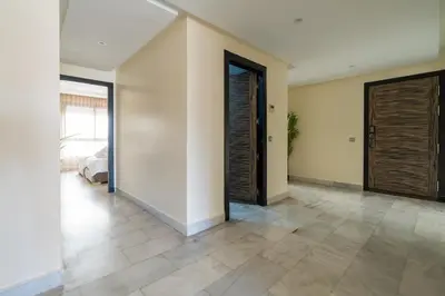 an empty room with a hallway with doors and a bedroom at Yacht appartement Waterfront Complex 2 Bedrooms 2 Bathrooms in Casablanca