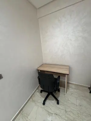 a desk and a chair in a room with a wall at Cosy Studio meublé in Casablanca