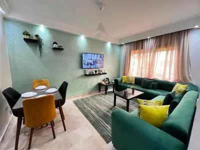 a living room with a green couch and a table at Morocco House in Casablanca