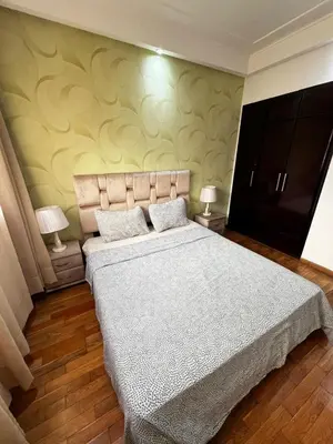 a bedroom with a large bed and two lamps at Morocco House in Casablanca