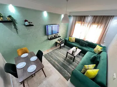 a living room with a green couch and a table at Morocco House in Casablanca