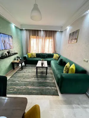 a living room with a green couch and yellow pillows at Morocco House in Casablanca