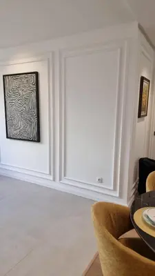 a dining room with a framed art on the wall at majorelle luxury in Rabat