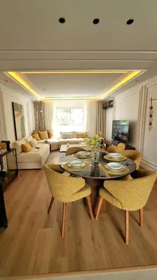 a living room with a table and chairs at majorelle luxury in Rabat