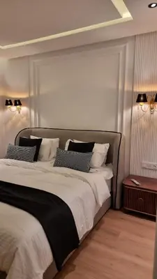 a bedroom with a large bed with white sheets and pillows at majorelle luxury in Rabat