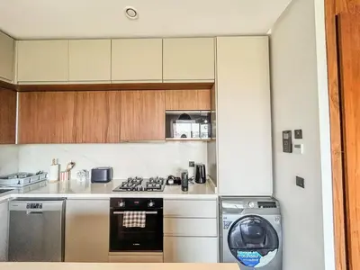 a kitchen with a stove and a washer and dryer at CFC Casablanca - Luxury 1-Bedroom Apartment with Anfa Park View in Casablanca