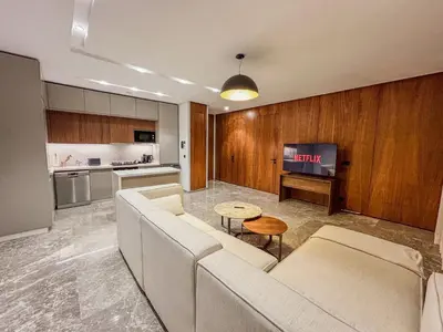 a living room with a couch and a table at CFC Casablanca - Luxury 1-Bedroom Apartment with Anfa Park View in Casablanca