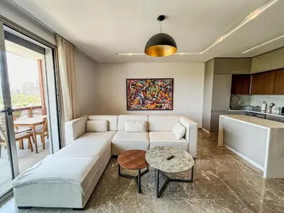 a living room with a couch and a table at CFC Casablanca - Luxury 1-Bedroom Apartment with Anfa Park View in Casablanca