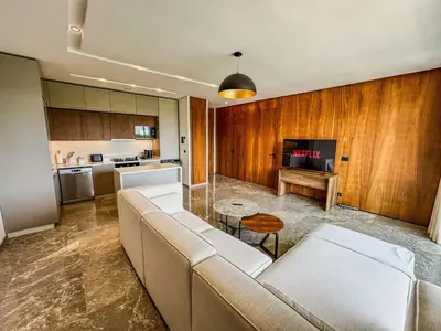 a living room with a couch and a table at CFC Casablanca - Luxury 1-Bedroom Apartment with Anfa Park View in Casablanca