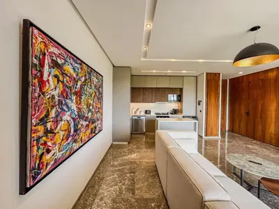 a living room with a large painting on the wall at CFC Casablanca - Luxury 1-Bedroom Apartment with Anfa Park View in Casablanca