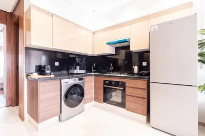 a kitchen with a washing machine and a refrigerator at C06 Apartment - Luxury, Style & Wellness in Casablanca