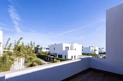 a white balcony with a view of white buildings at Villa Indigo in Rabat
