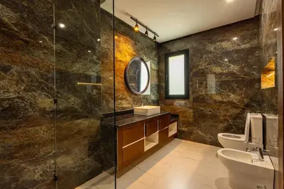 a bathroom with a sink and a glass shower at Villa Indigo in Rabat
