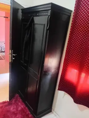 a black cabinet in a room next to a bed at Belle chambre pour 2 sidi maarouf in Casablanca