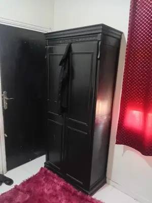 a black door in a bathroom with a pink rug at Belle chambre pour 2 sidi maarouf in Casablanca