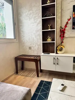 a living room with a bench in a cabinet at Appartement à 2 min Gare agdal in Rabat