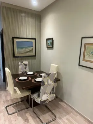 a dining room with a wooden table and chairs at Appartement à 2 min Gare agdal in Rabat