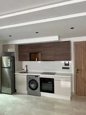 a kitchen with a stove and a dishwasher at L'osmo - 1 BR - 2m from CFC in Casablanca
