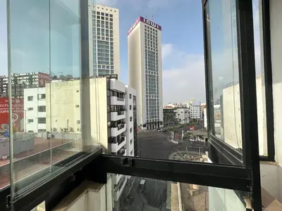 a view of a city street from a window at Luxury Modern Apartment in the Heart of the City with Balcony Overlooking Twin Towers in Casablanca