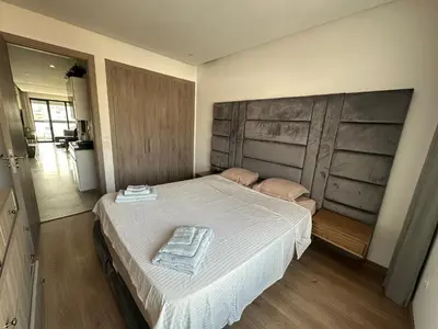 a bedroom with a bed with a towel on it at Luxury Modern Apartment in the Heart of the City with Balcony Overlooking Twin Towers in Casablanca