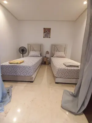 two twin beds in a room with at La perle home 21 in Casablanca-Port