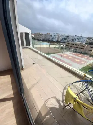 a balcony with a view of a tennis court at La perle home 21 in Casablanca-Port