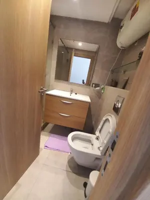 a bathroom with a toilet and a sink and a mirror at La perle home 21 in Casablanca-Port