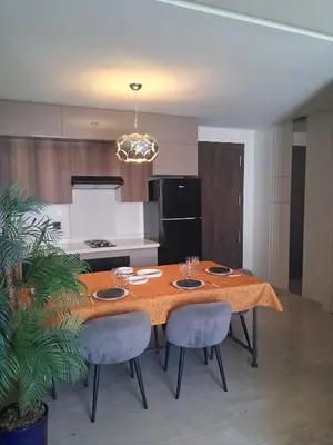 a kitchen with a table with chairs and a kitchen with a stove at La terrasse in Casablanca
