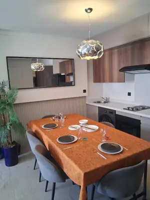 a kitchen with a wooden table with chairs around it at La terrasse in Casablanca