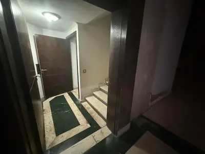 a hallway of a bathroom with a toilet and a mirror at Aziz in Casablanca