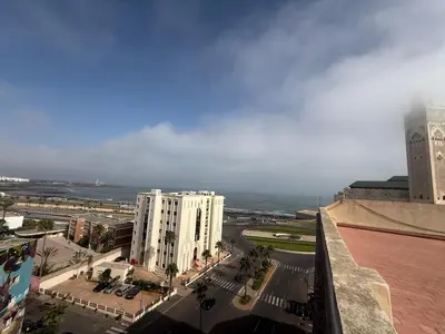 a view of a city with buildings and the ocean at Aziz in Casablanca