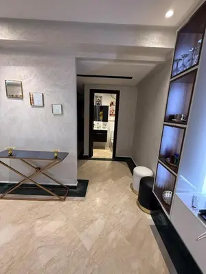 a living room with a table and a hallway at Aziz in Casablanca