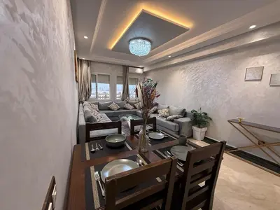 a living room with a table and a couch at Aziz in Casablanca