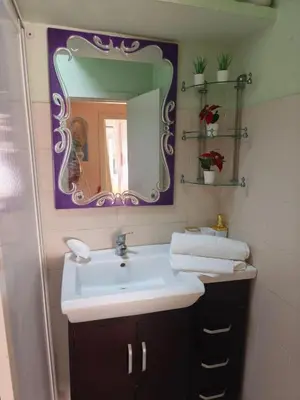 a bathroom with a sink and a mirror at Baraka house in Sidi Yahia az Zaʼer