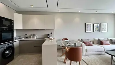 a kitchen and living room with a couch and a table at Anfa The Address - By AppartAli in Casablanca